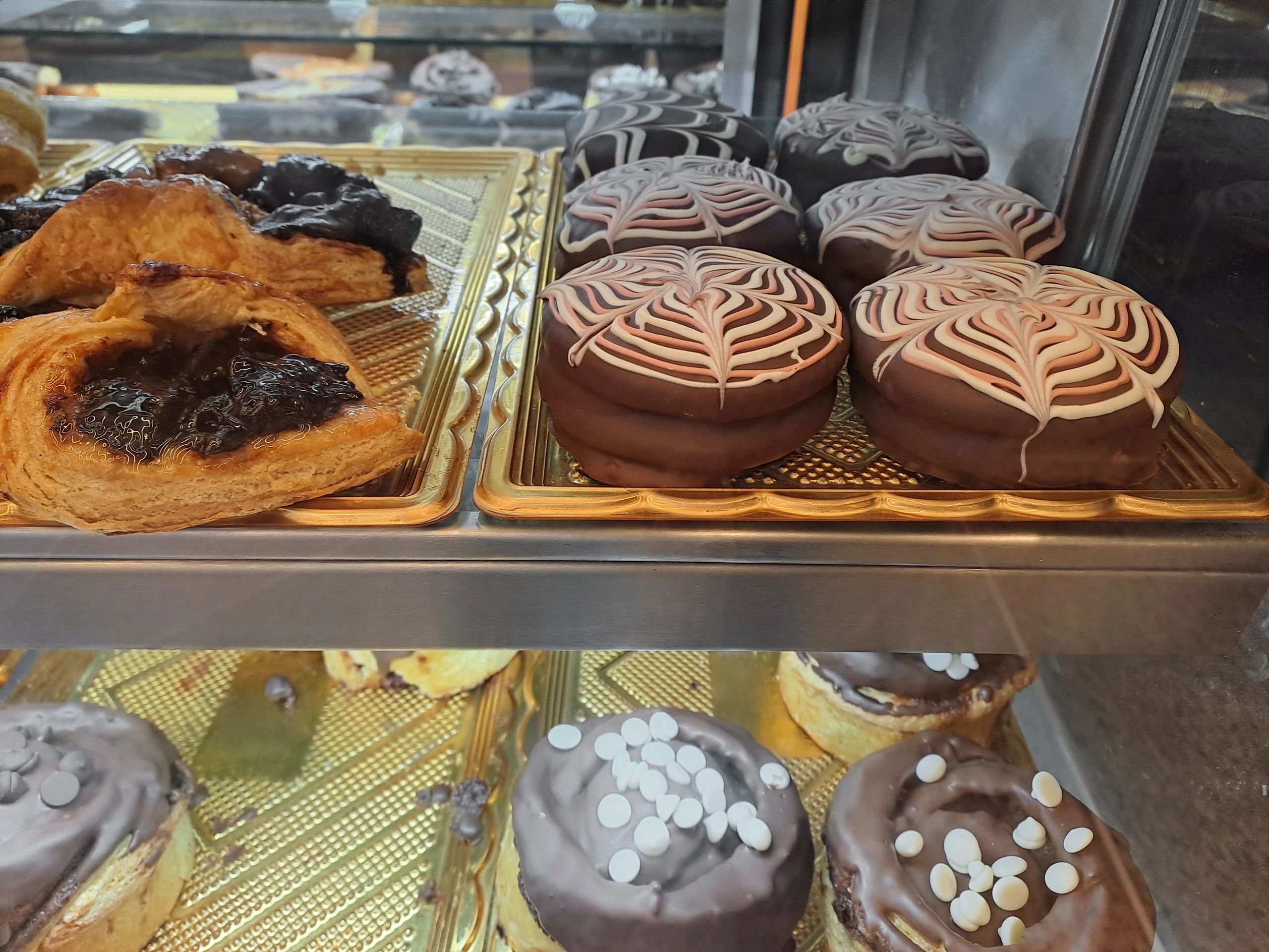 Assorted pastries and donuts in a bakery showcase